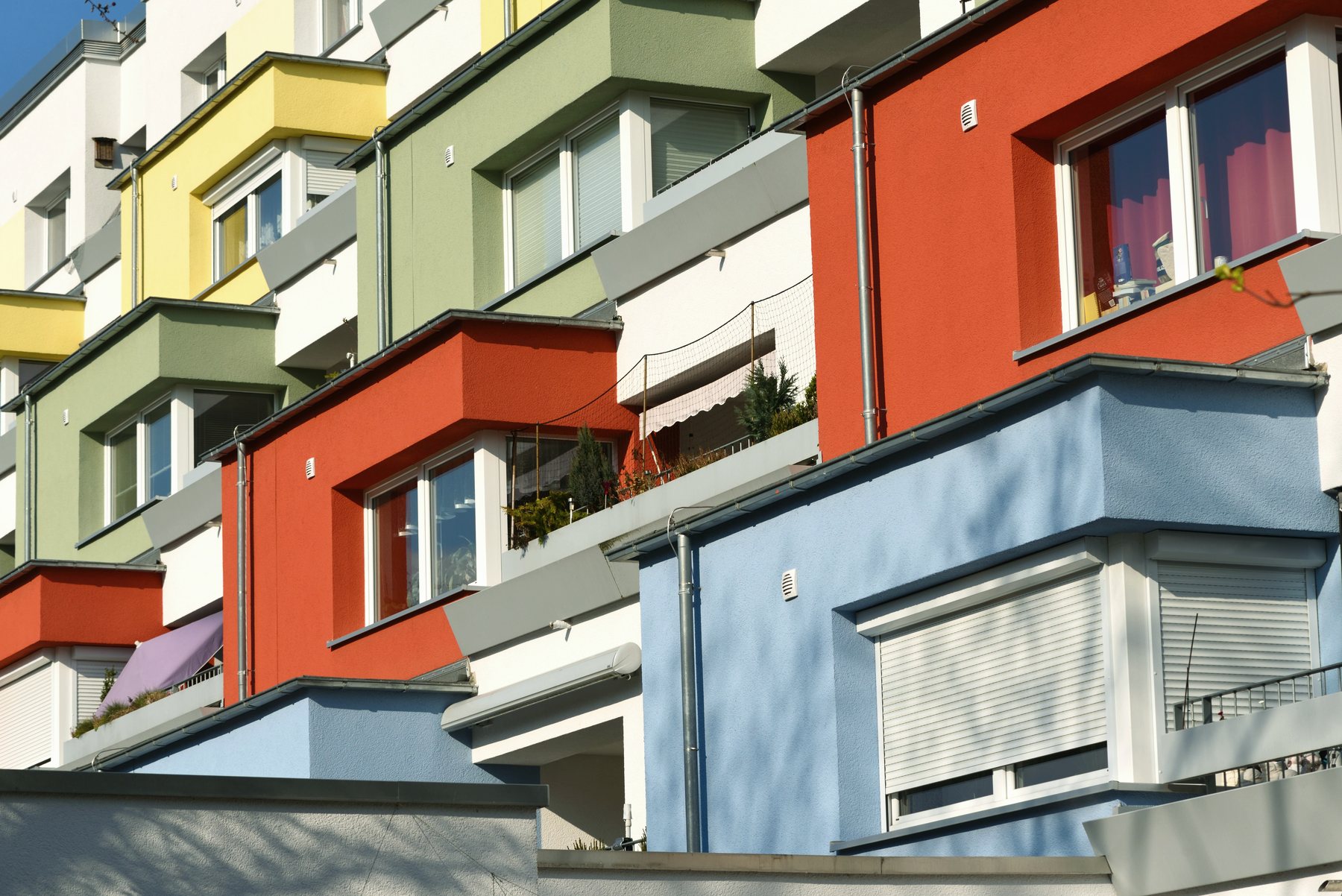 The facade of an apartment block painted in blocks of colour.