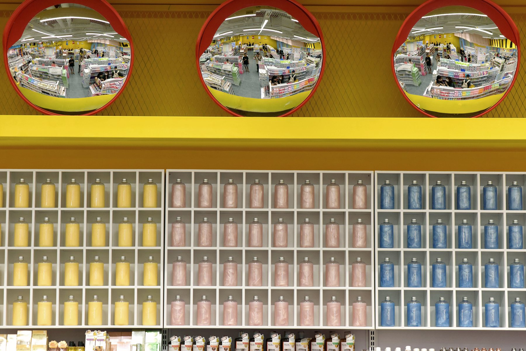 A bright warehouse interior lined with colourful stocked shelving.